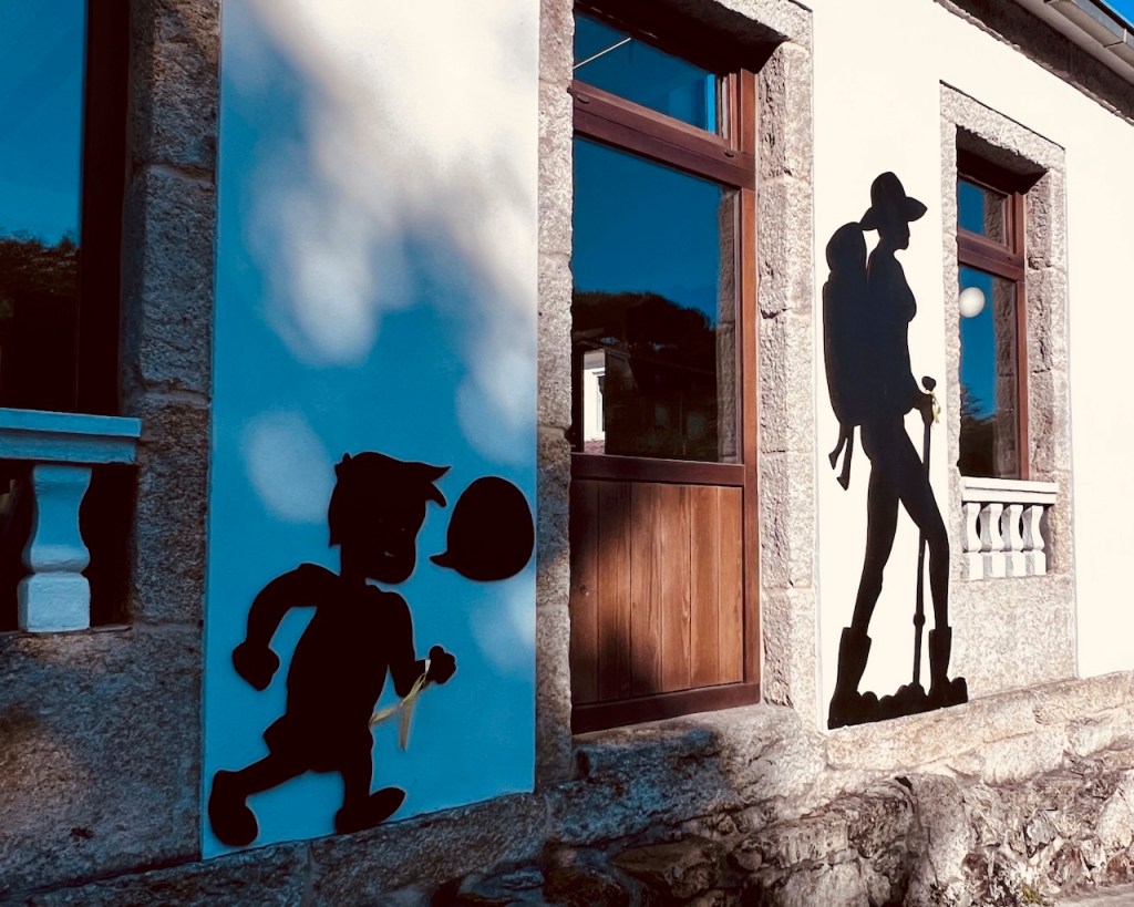 Two shadow figures on a wall depicting a child running with a balloon and a hiker with a backpack.